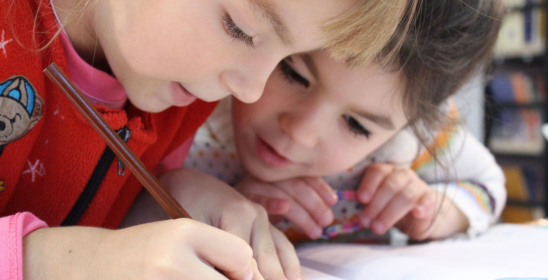 Children writing at a table