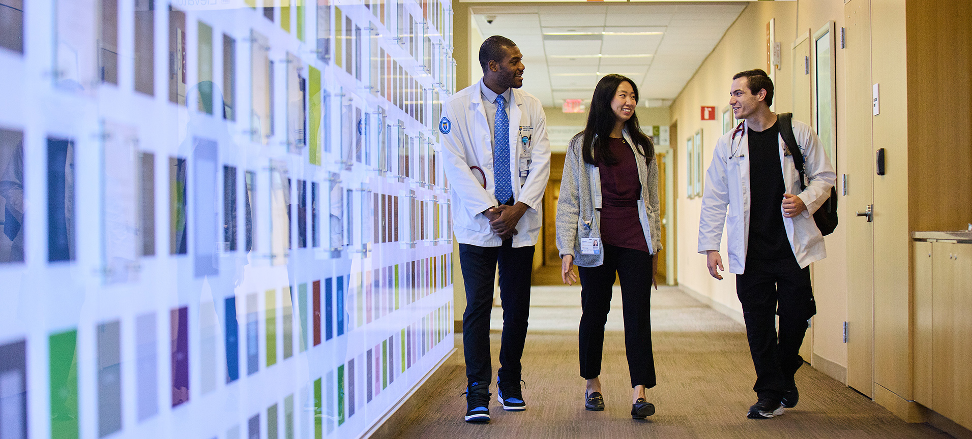Three SOM medical students talk as they walk down the hallway at Virtua Hospital in Voorhees