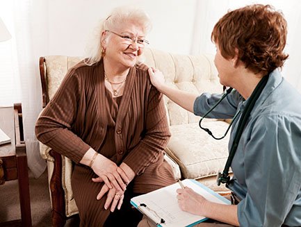 A woman consults with a provider in her home.
