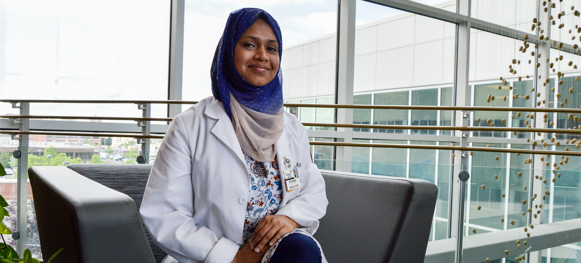 Resident sitting in atrium of Rowan Medicine